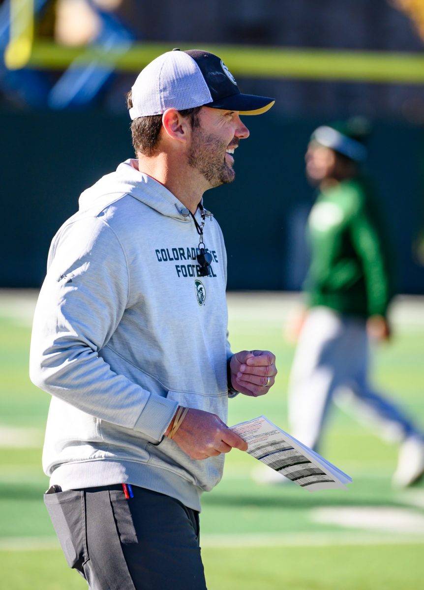 Colorado State University football interim head coach Tyson Summers smiles to another coach during football practice Oct. 21. Summers was named as interim head coach Oct. 19 after former head coach Jay Norvell was removed from his coaching duties
