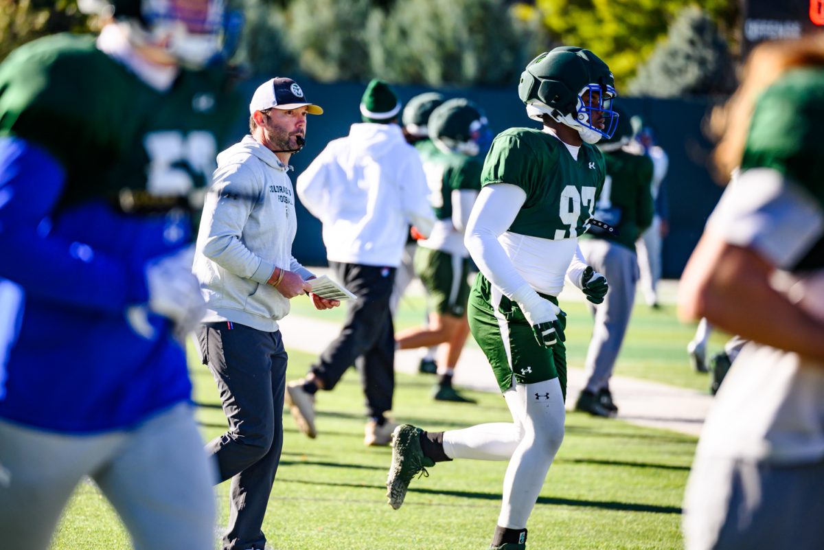 Colorado State University football interim head coach Tyson Summers walks defensive players over to join the offense for team drills during football practice Oct. 21. Summers was named as interim head coach Oct. 19 after former head coach Jay Norvell was removed from coaching duties. 