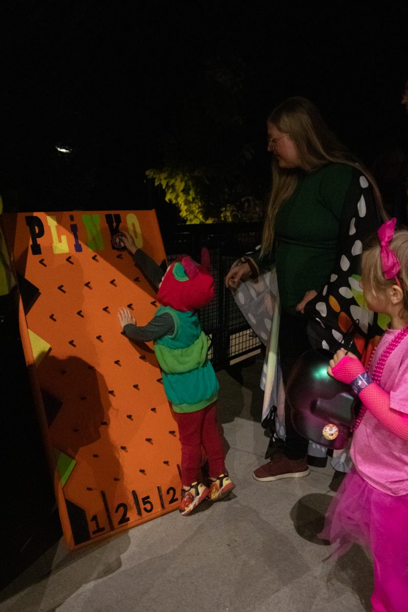 A child dressed as "The Very Hungry Caterpillar" plays plinko at Pumpkins on Parade at the Gardens on Spring Creek Oct 24.