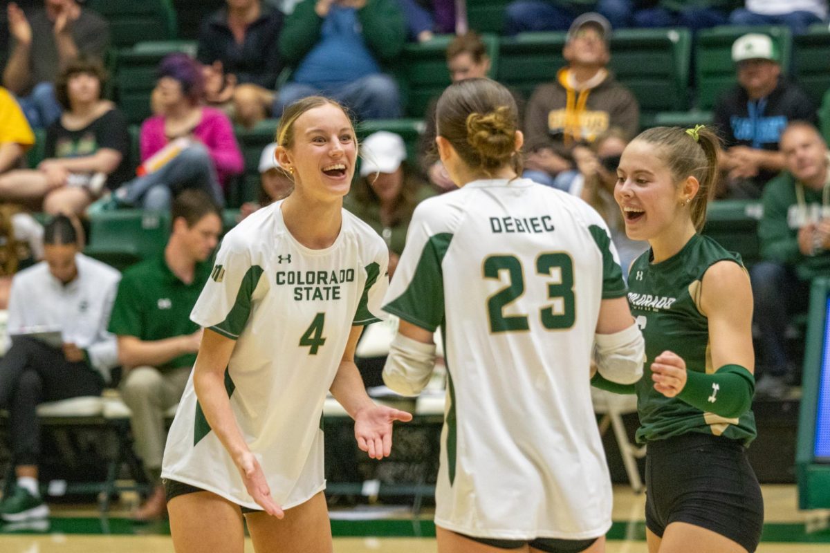 Halle Jameson (4) and teammate Erin Debiec (23) celebrate a point. Colorado State University played against University of Wyoming in Moby Arena winning 3-0 Oct 25.