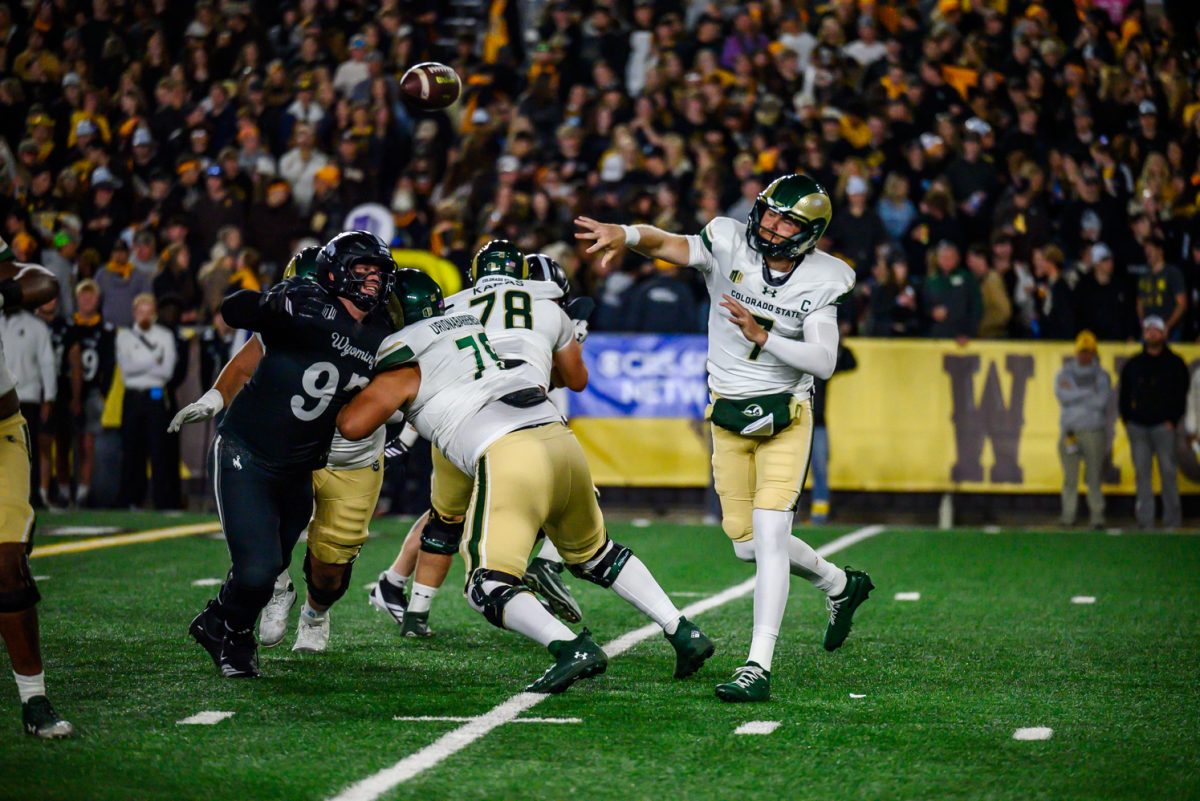 Colorado State University football quarterback Jackson Brousseau (7) throws the ball to a teammate while facing pressure from the University of Wyoming's defense Oct. 25.
