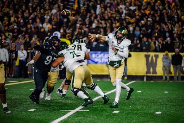 Colorado State University football quarterback Jackson Brousseau (7) throws the ball to a teammate while facing pressure from the University of Wyoming's defense Oct. 25.