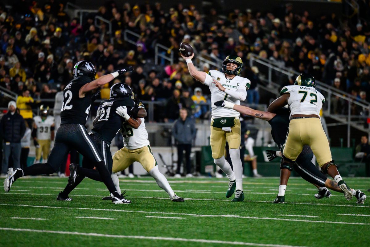 Colorado State University football quarterback 
Jackson Brousseau (7) throws the ball to a wide receiver before being tackled by the University of Wyoming defense during CSU's game against UW Oct. 25.
