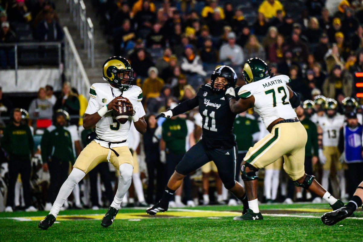 Colorado State University football quarterback Darius Curry (3) looks for a teammate to throw to while being rushed by the University of Wyoming's defense Oct. 25.