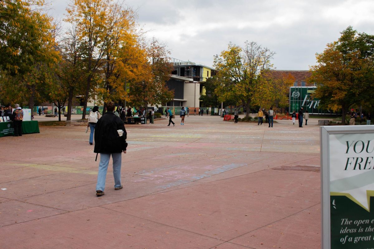 Students walk past the remnants of removed chalked messages on The Plaza Oct 7. Chalk messages were erased per a 2025 free speech policy update. 