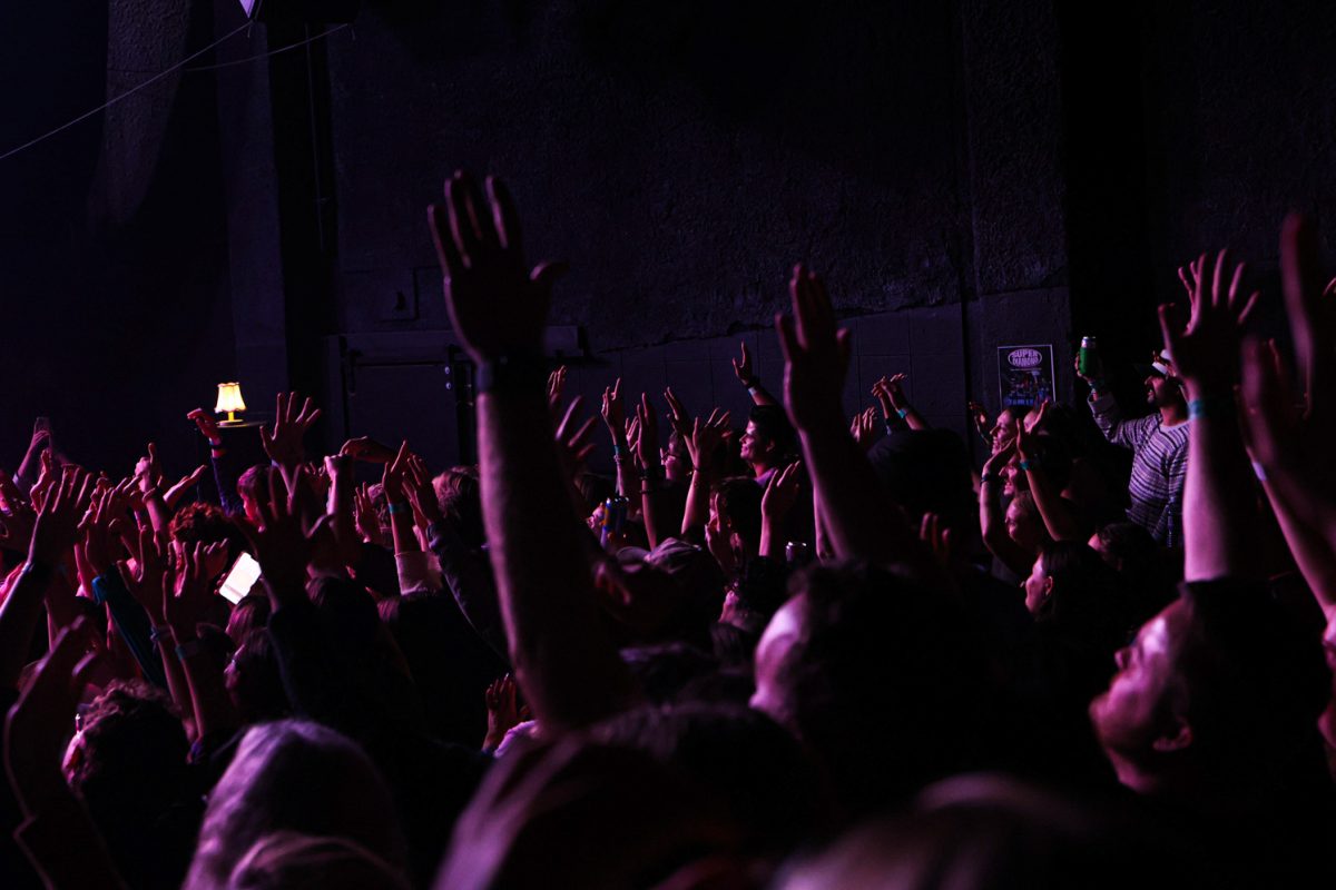 Audience members at the Oliver Hazard and The Last Revel show put their hands up for a crowd photo at the Aggie Theatre Oct. 9. “They were so interactive with the crowd, it seemed like they really wanted to be here,” said Ashlyne Grubb, an audience member that has attended three of Oliver Hazards Colorado shows. 
