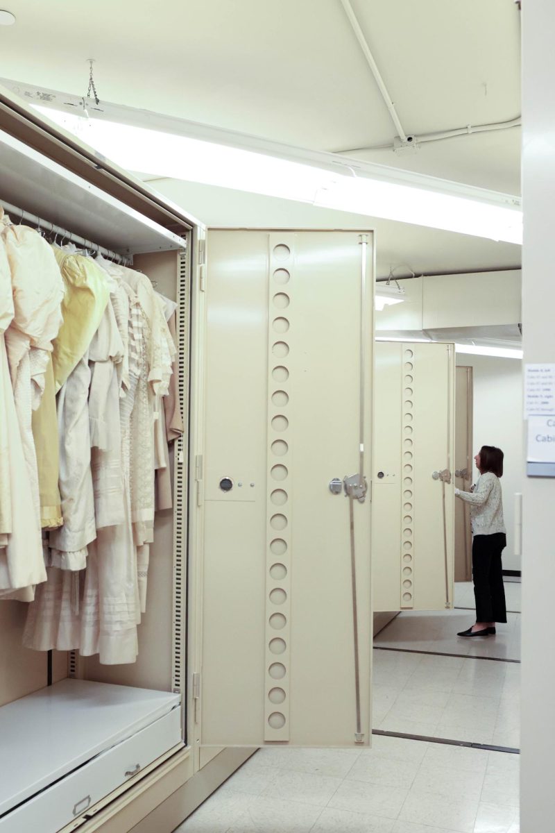 Interim Director of the Avenir Museum, Megan Osborne, sorts through decades of wedding dresses that are held in the museum's archived textile and garment collection, Oct. 6. 