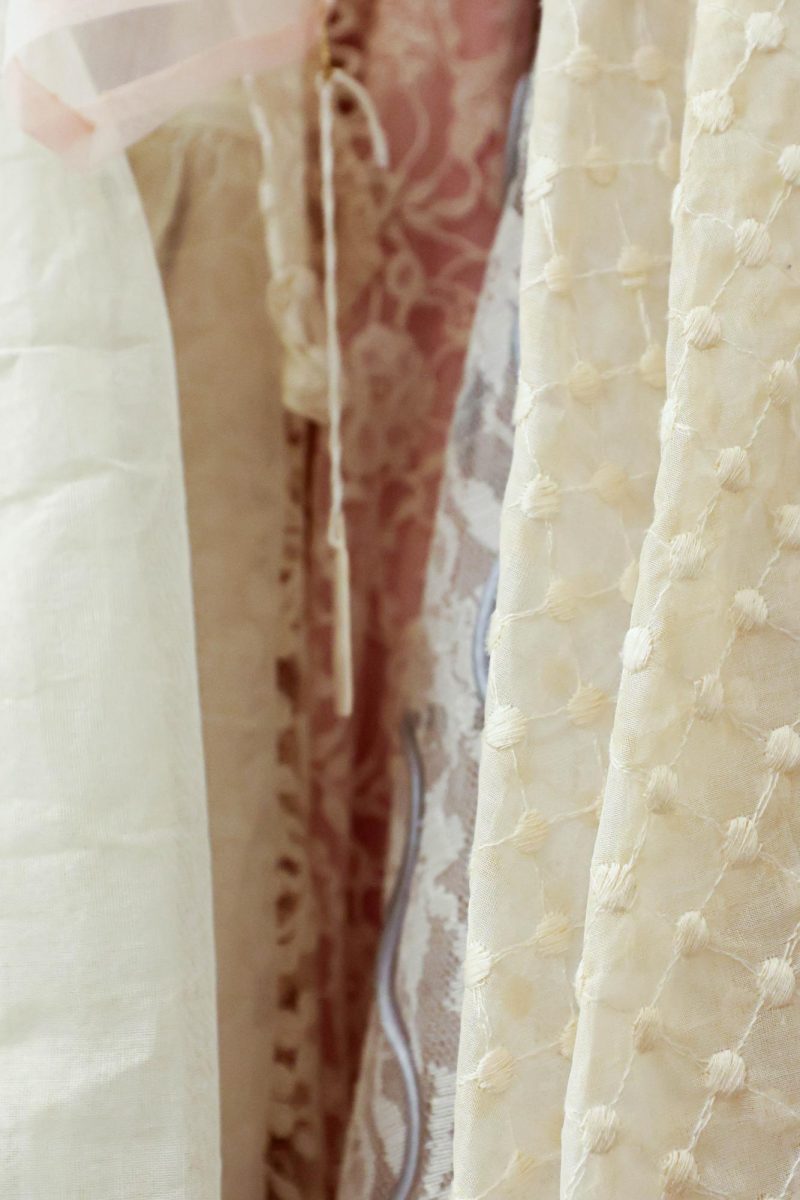 Fabrics of wedding dresses hang in the Avenir Museum. Showcasing the variety of fabrics, designs, and styles for each time period, Oct. 6.
