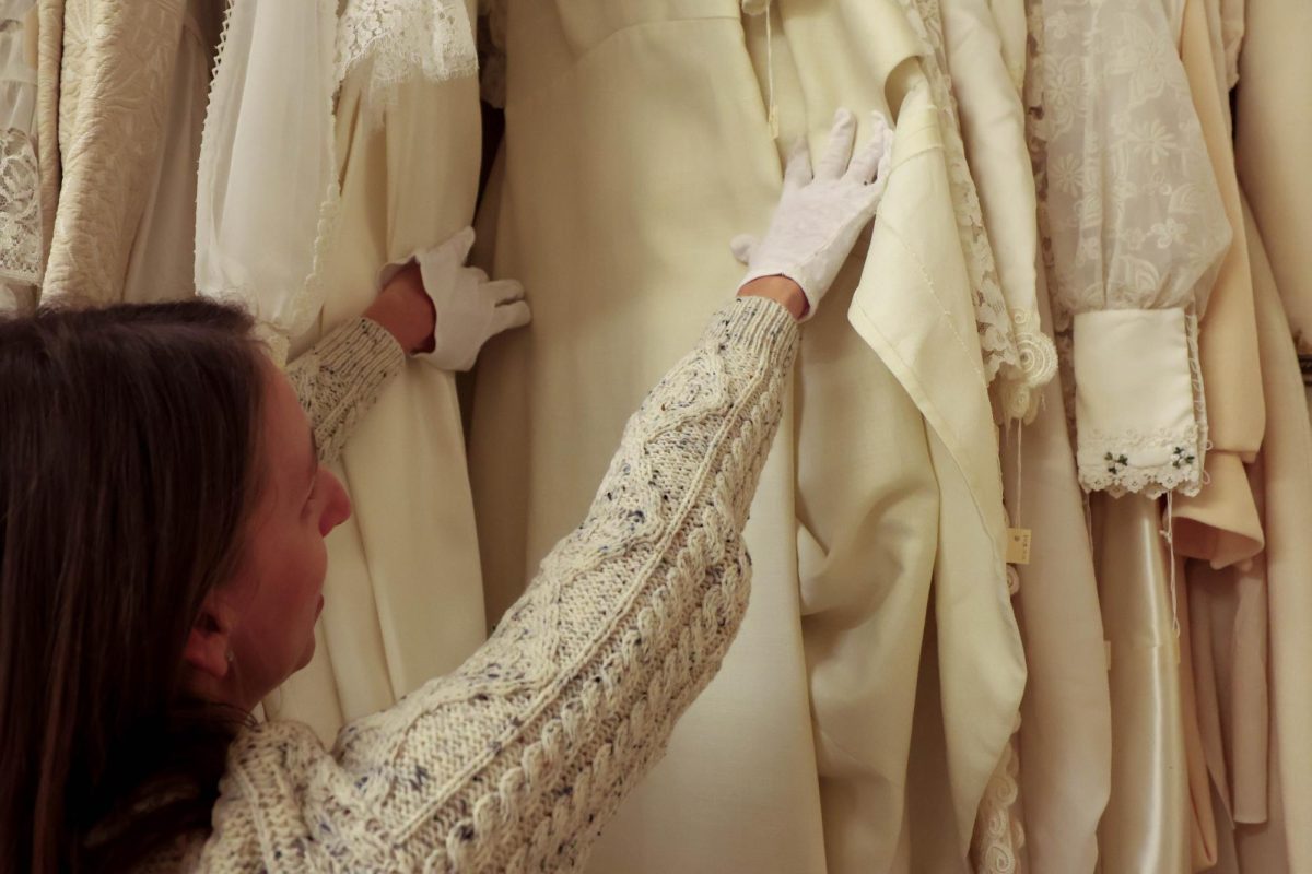 Interim Director of the Avenir Museum, Megan Osborne, sorts through wedding dresses from the 1960s, held in the museum's archived textile and garment collection, Oct. 6. 
