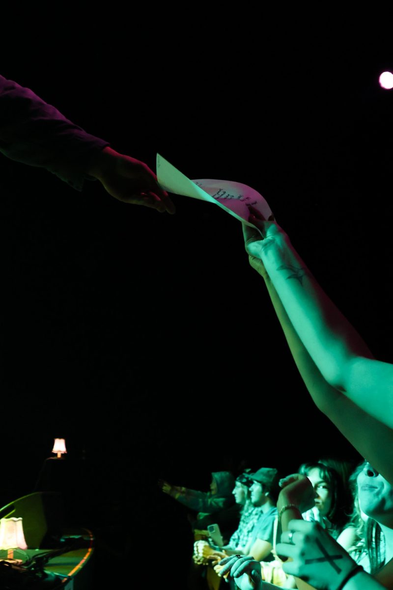 The set list from band Oliver Hazard gets handed off to fan after performance at the Aggie Theatre, Oct. 9. The band played songs from their four albums including their debuting album 34 N. River as well as their recently released  album Raindrop River.  