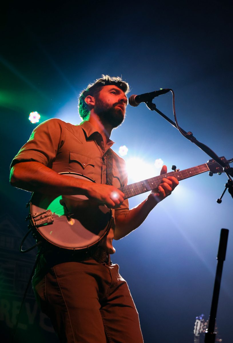 Ryan Acker sings and plays banjo with his band, The Last Revel, at the Aggie Theatre Oct. 9.  
