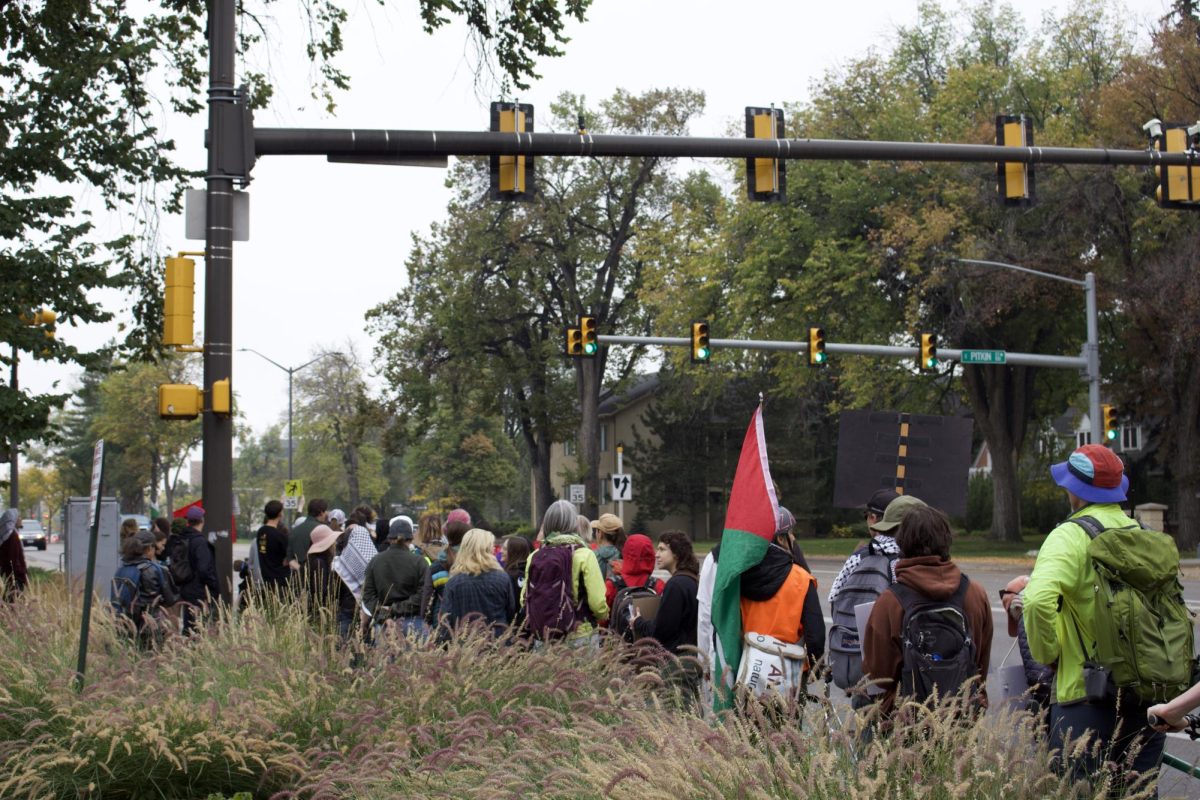 Demonstrators march along College Avenue in the first stretch of a 14 mile walk to show solidarity with displaced Palestinians Oct. 11.