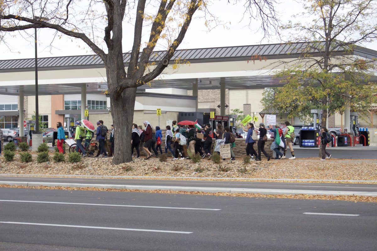A group of pro-Palestine demonstrators marches past a shopping center on College Avenue in a 14 mile "Walk to Al-Mawasi" Oct 11. to protest the displacement of Palestinians in the Israel-Hamas war.