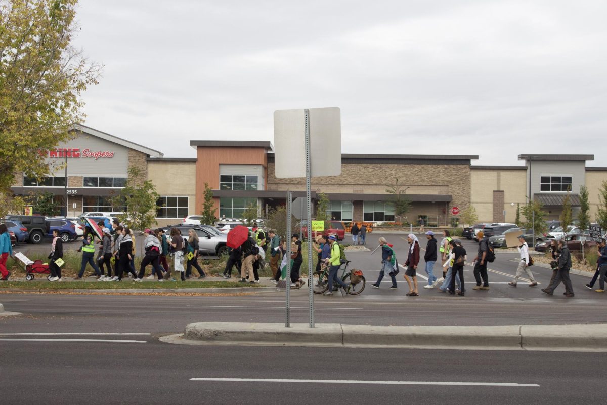 A group of community members marches past a King Soopers grocery store on South College Avenue chanting "while you're shopping bombs are dropping" in an Oct. 11 demonstration meant to show solidarity with Palestinians who were displaced in the Israel-Hamas war.