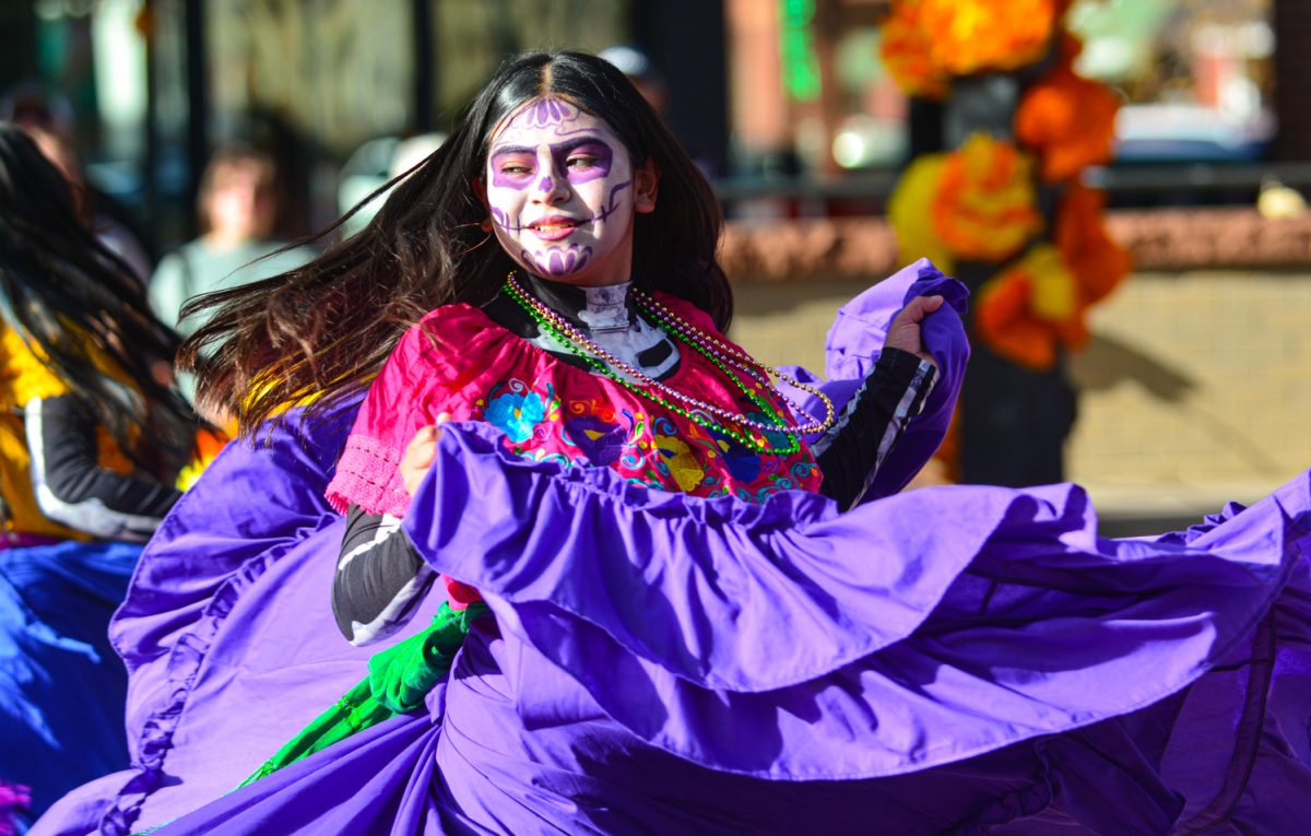 A vibrant dancer represents Mexican culture through traditional dances alongside her two dance partners Nov. 1. This holiday celebrates life and honors the dead in a festive celebration through dance, music and food. 