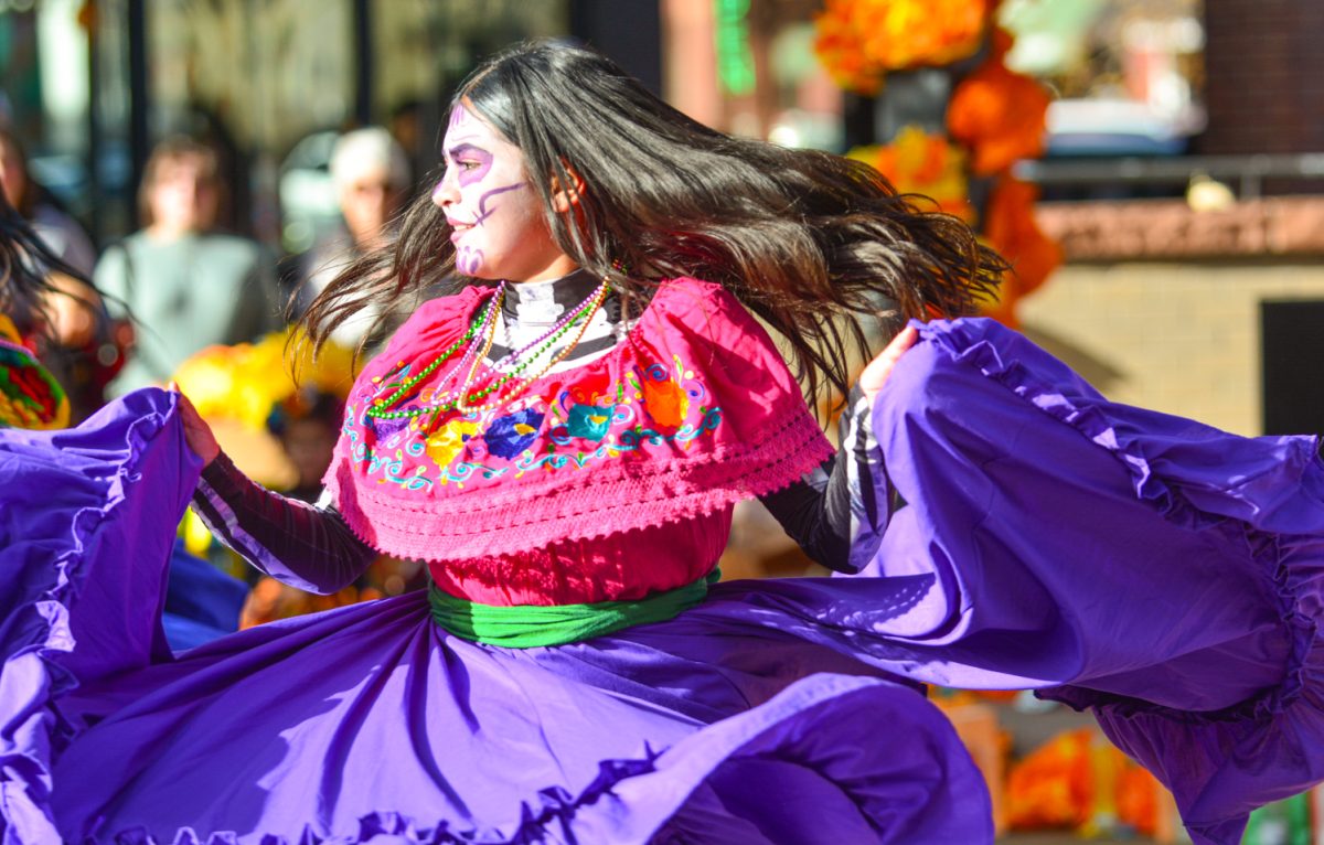 A dancer performed a traditional Mexican dance to celebrate Dia de Los Muertos Nov. 1. As a part of the celebration of this festive holiday, many people paint their faces as a sugar skull to honor the dead and celebrate life. 