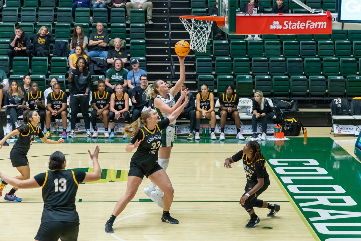 A basketball player shoots the ball during a game.