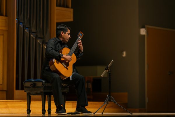 A performer plays guitar.