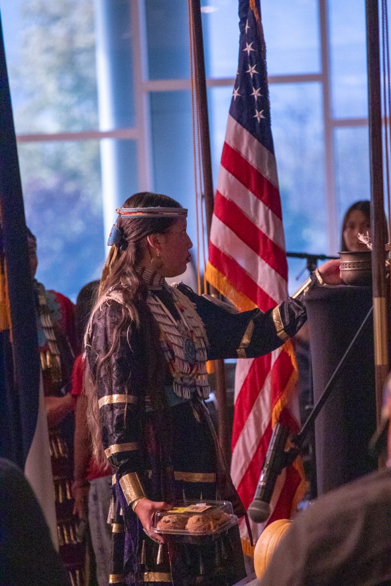 A participant goes up to claim a cake that was won during the cake walk at the American Indian Science and Engineering Society Powwow Nov 1. The Powwow is the 41st in Colorado State University history.