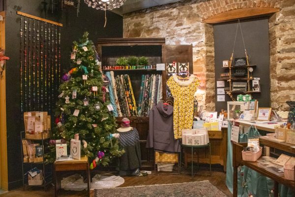 Materials available for purchase sit on a shelf underneath a sign advertising an Open Stitch Night at The Twisted Stitch Nov. 22. The store opened May 1, Nadia Hare said, who is one of the owners.