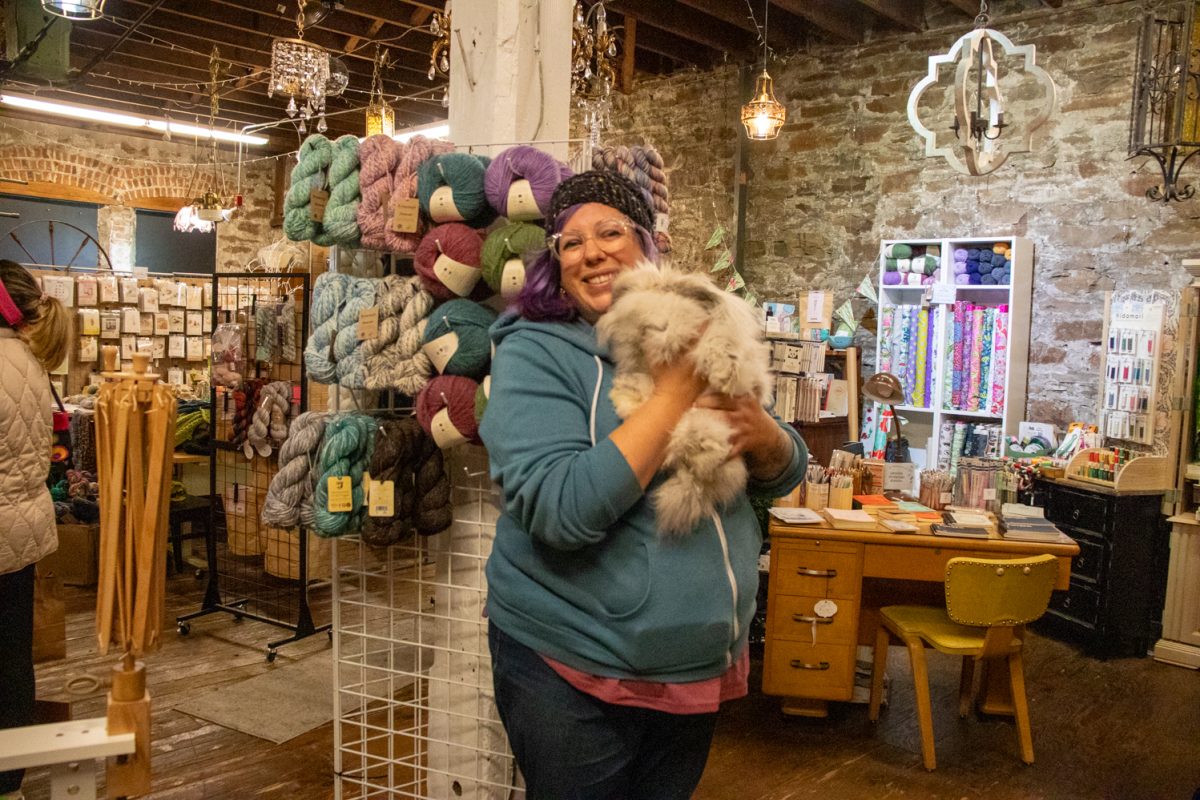 Nadia Hare, one of the owners of the Twisted Stitch, holds Princess Pippa LaFloof in the store Nov. 22. Hare says the store opened May 1.