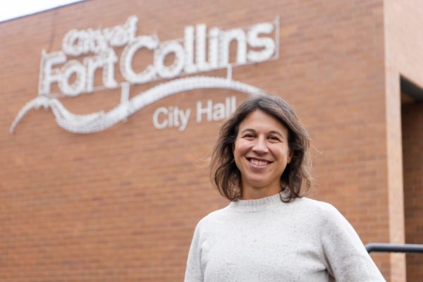 Fort Collins Mayor-elect Emily Francis smiles for a photo outside City Hall’s brick building Nov. 21. “Fort Collins is dealing with the tension of being a very pro-climate city, like, how do we address climate issues, and wanting to invest a lot in that,” Francis said. “But we're at a point where that investment is making it more costly to live in Fort Collins.”