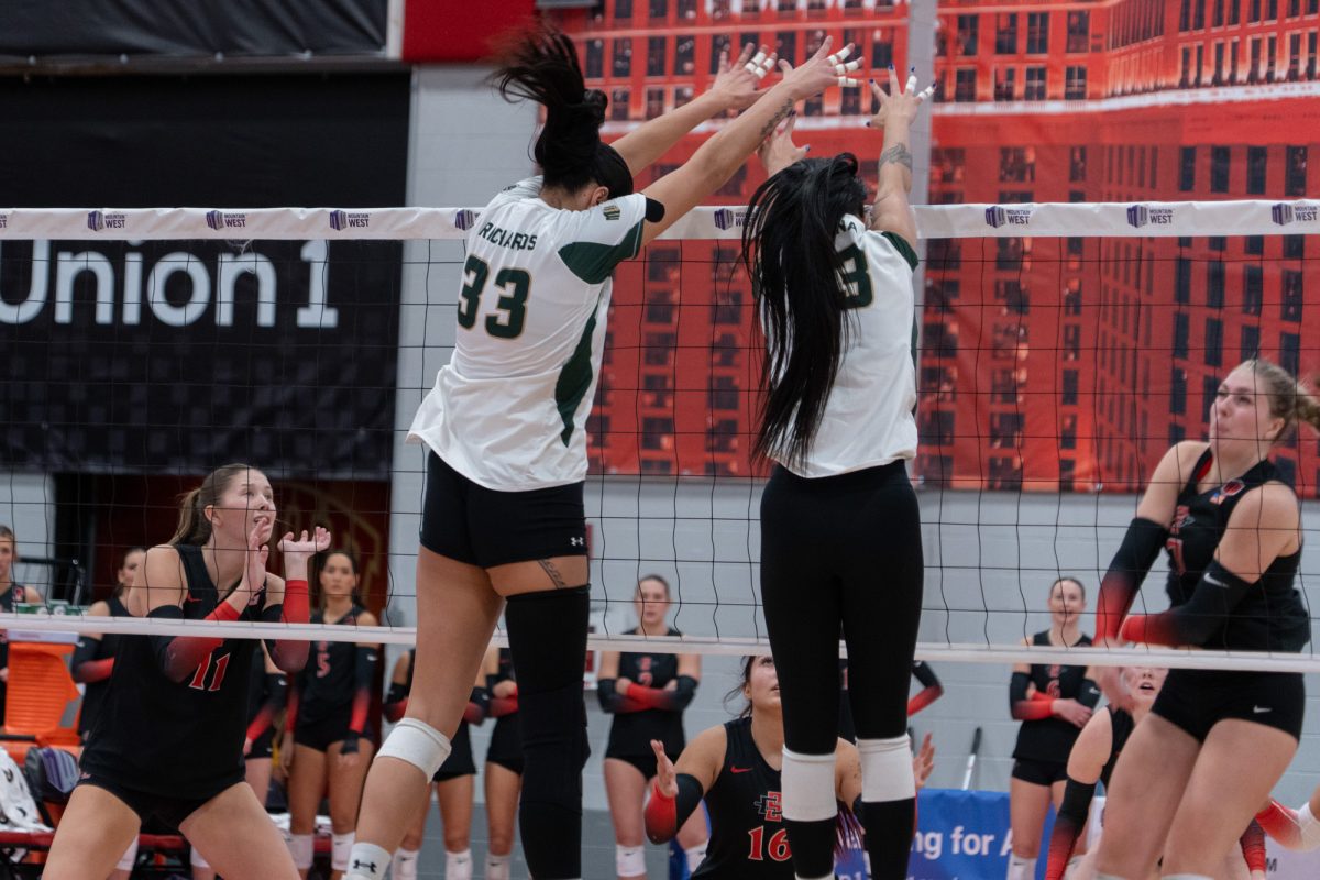 Kekua Richards (33) and Jazen Debina (13) go up for a block in Colorado State University's match against San Diego State University. CSU won 3-1.