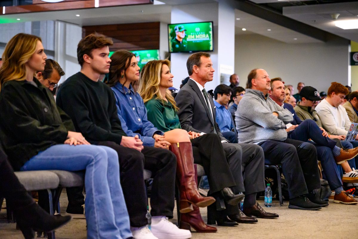 Head football coach Jim Mora sits with his family during Colorado State University's press conference held in Canvas Stadium Dec. 1.