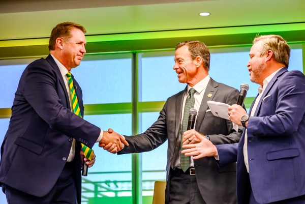 Director of Athletics John Weber shakes hands with new head football coach Jim Mora and Broadcasting Director Brian Roth after a round of questions at a press conference in Canvas Stadium Dec. 1, 2025.