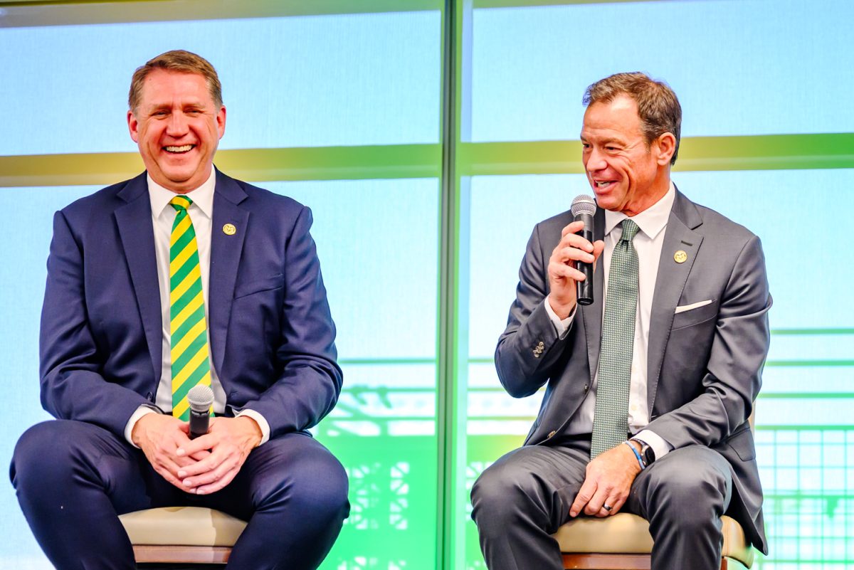 Director of Athletics John Weber laughs at a joke made by head football coach Jim Mora during an introductory press conference in Canvas Stadium Dec. 1.