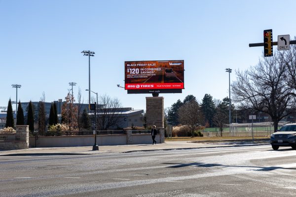A billboard on the corner of a roadway