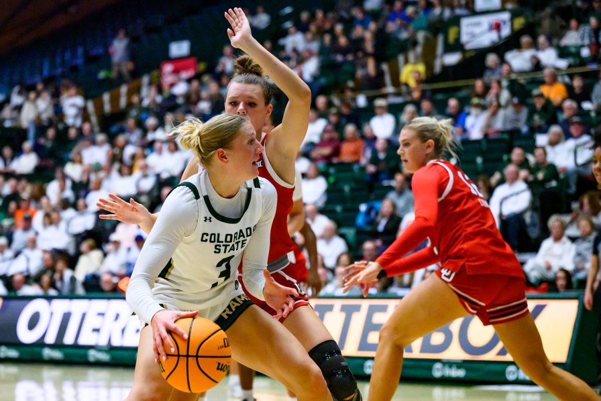 Colorado State University women's basketball guard Lexus Bargesser (3) looks for a way around a University of Utah defender during CSU's game against UU in Moby Arena Dec. 4.