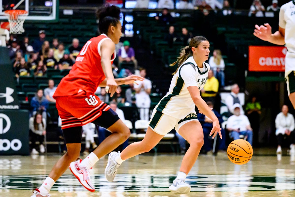Colorado State University women's basketball guard Brooke Carlson (2) dribbles around a University of Utah defender and looks for a teammate to pass to during CSU's game against UU Dec. 4.