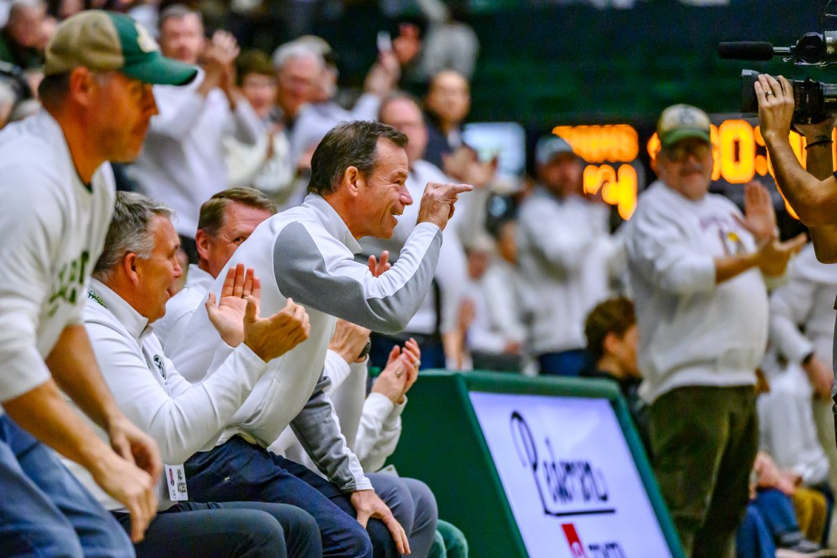 Colorado State University head football coach Jim Mora holds up a ram hand sign to a camera at a CSU women's basketball game against the University of Utah Dec. 4. Mora was named the new head coach of CSU football a few weeks after former head coach Jay Norvell was removed from the position mid-season.