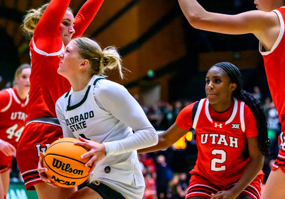 Colorado State University women's basketball guard Lexus Bargesser (3) pushes through University of Utah defenders to take a shot during CSU's white-out game against UU Dec. 4.