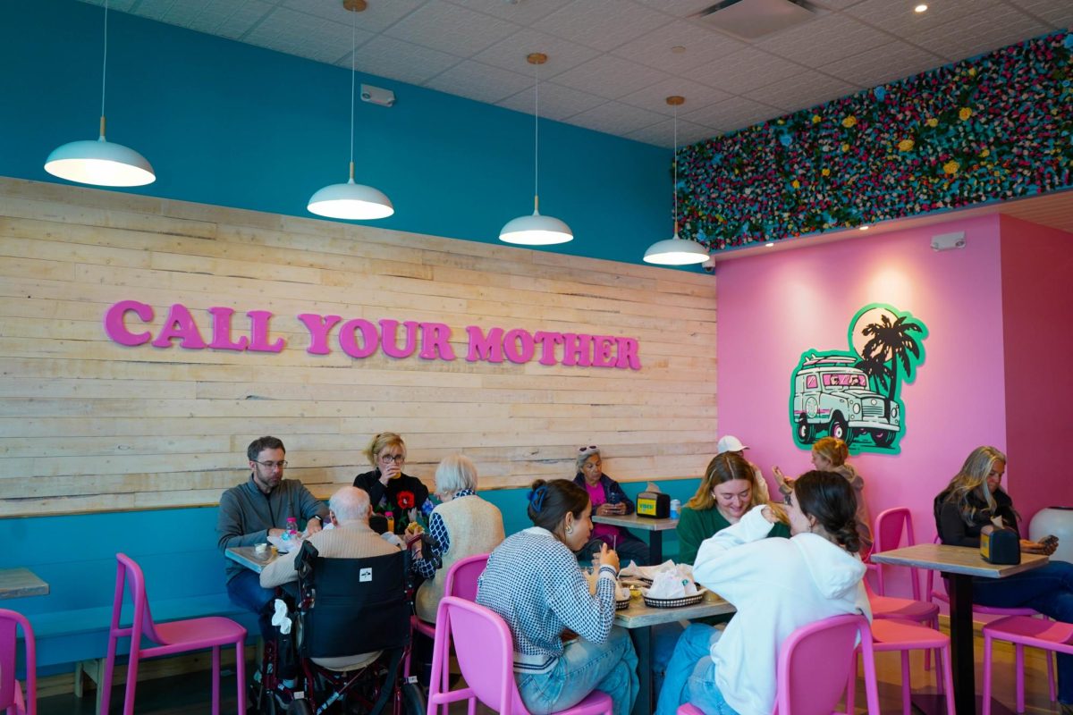Customers sit in the inside of Call Your Mother Deli Dec. 12. The popular east coast-based bagel chain serves bagel sandwiches, coffees and treats. 