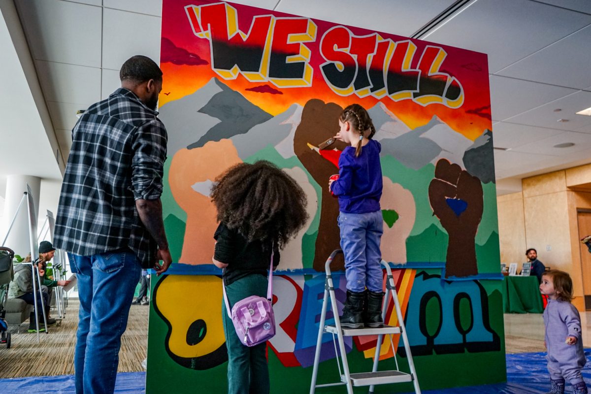 Participants at the 2026 Dr. Martin Luther King Jr. Celebration engage with a collaborative community mural in partnership with the Fort Collins Mural Project Jan. 19. Attendees were given cups of paint and brushes to add to the pre-sketched design by FCPM.  