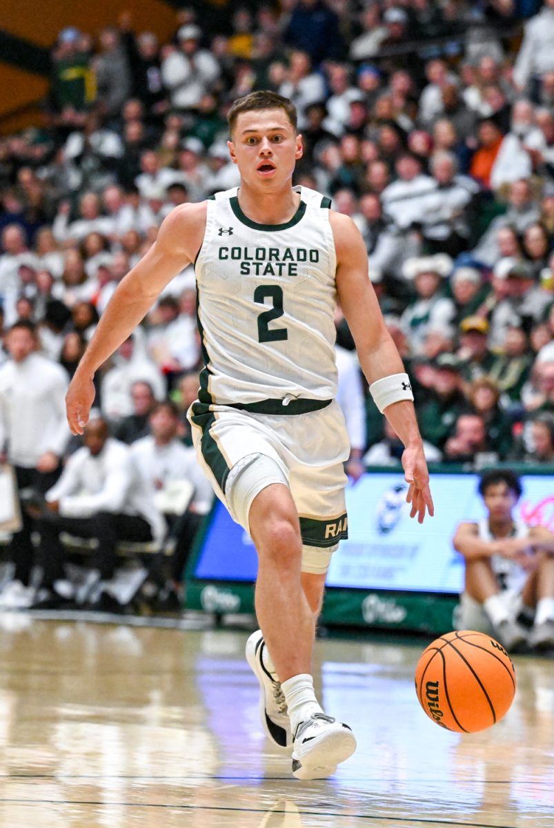 Colorado State UNiversity men's basketball guard Brandon Rechsteiner (2) breaks away from Utah State University's defense and dribbles down the court duirng CSU's game against USU Jan. 23.