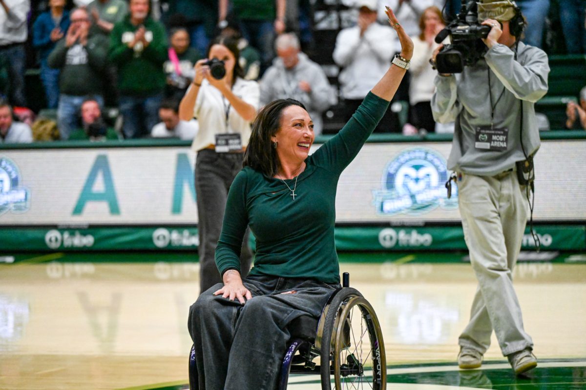 Olympic gold-medalist and Colorado State University alumn Amy Van Dyken waves to the crowd as she is recognized in Moby Arena during CSU's men's basketball game against Utah State University Jan. 23.