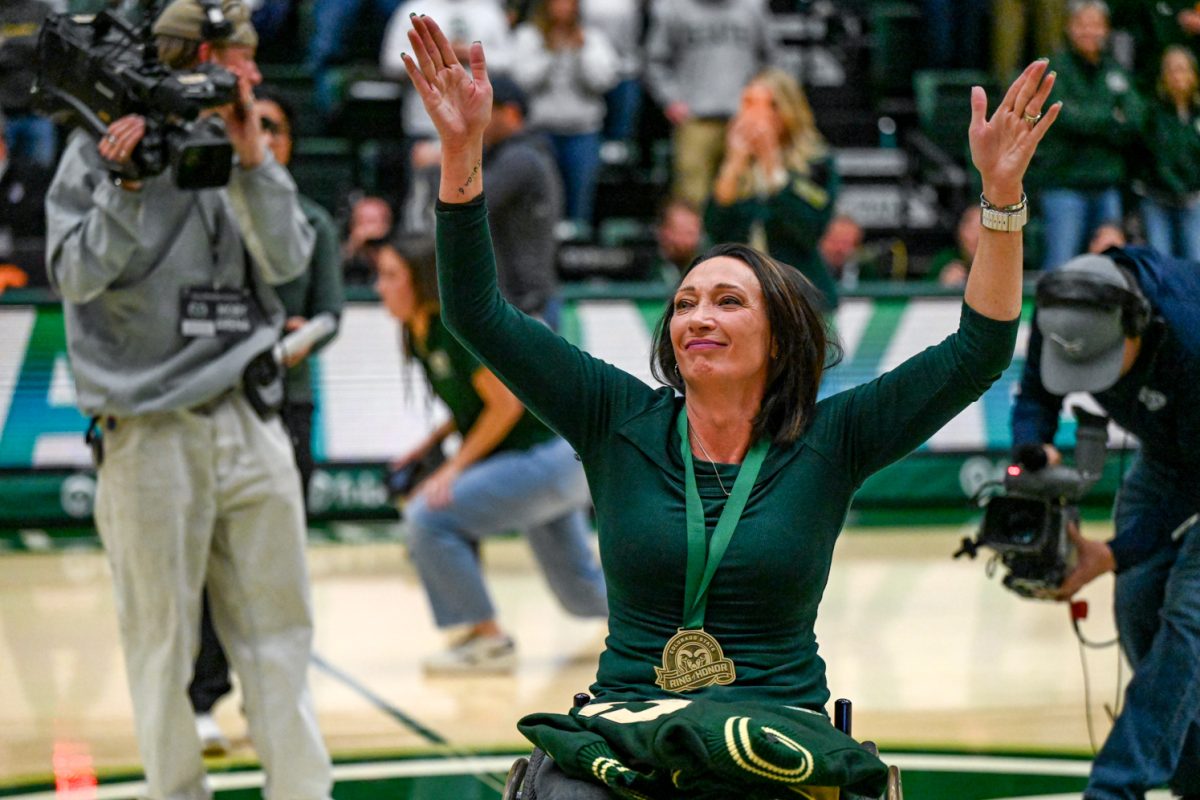 Olympic gold-medalist and Colorado State University alumn Amy Van Dyken waves to the crowd as she is recognized in Moby Arena during CSU's men's basketball game against Utah State University Jan. 23.
