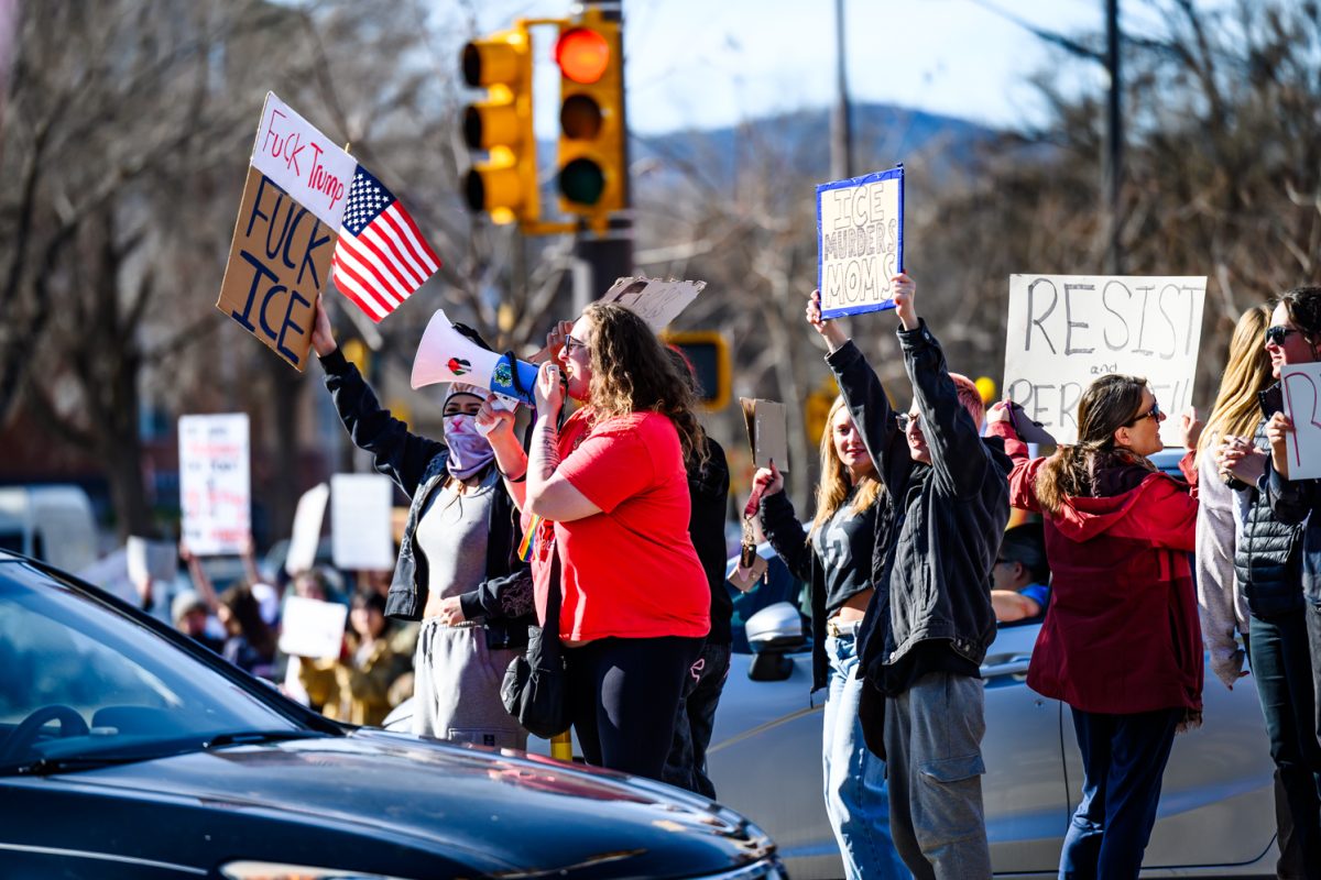 Protesters crowd the median on the intersection of College Avenue and Mulberry Street to demonstrate against ICE Jan. 30.