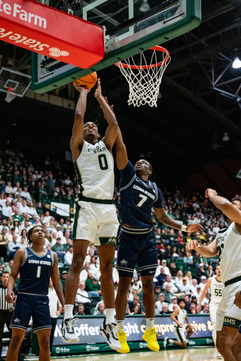 Colorado State University men's basketball forward Carey Booth (0) jumps for the basket during CSU's game against Utah State University Jan. 23.