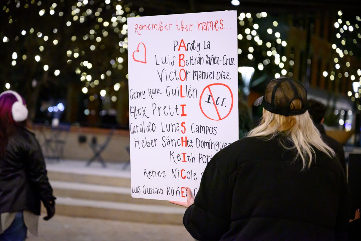 A protestor holds up a sign listing names of people who have been killed by ICE in recent operations throughout the country during a protest held in Old Town Square Jan. 29.
