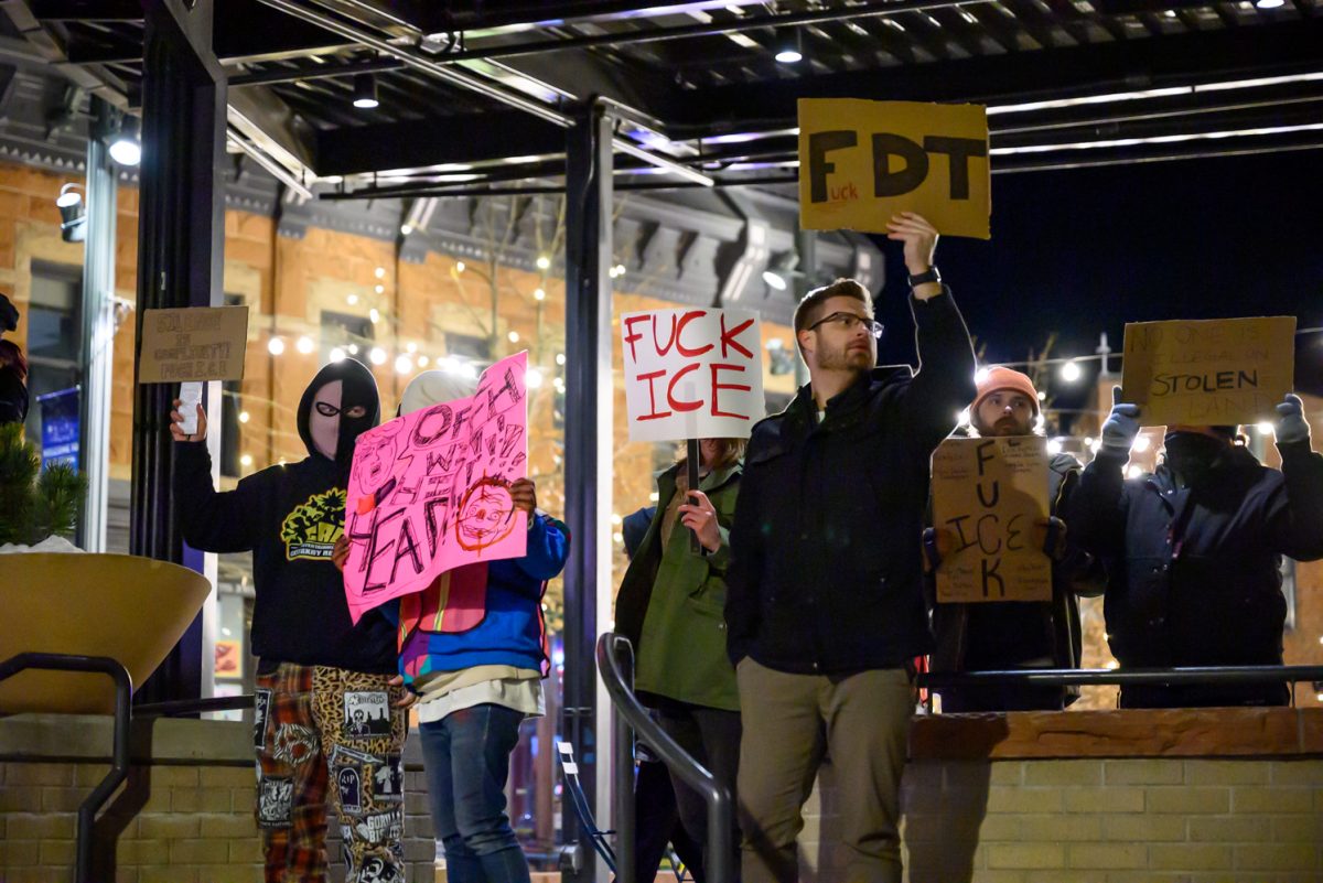 Protesters gather in Old Town Square holding signs and chanting to passing pedestrians and cars, demonstrating against ICE Jan. 29. The crowd chanted phrases such as, "Whose streets? Our streets!" and, "Fuck ICE."