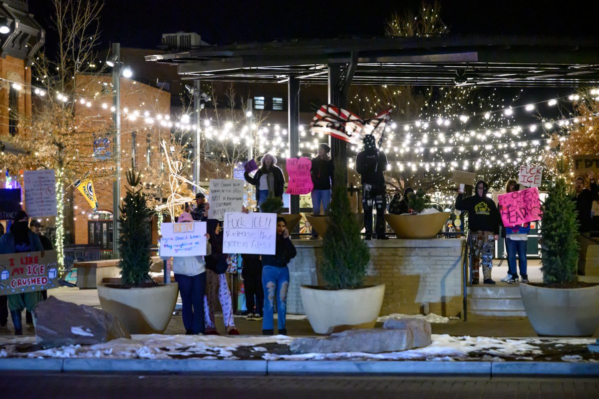 Protestors gather in Old Town Square holding signs and chanting to passing pedestrians and cars to demonstrate against ICE Jan. 29. The crowd chanted phrases such as, "Whose streets? Our streets!" and, "Fuck ICE."