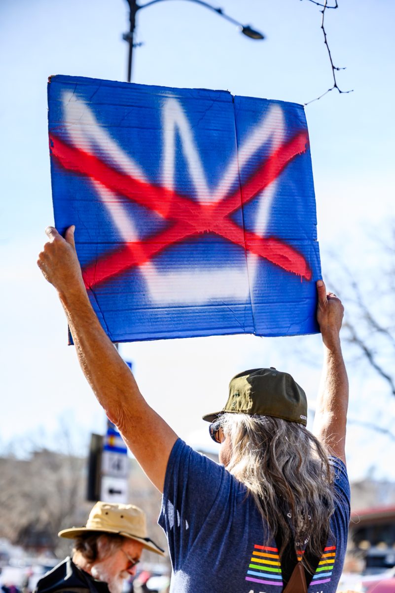 A protester holds up a "No Kings" sign and chants along with the crowd gathered to demonstrate against ICE on College Street Jan. 30. Some of the chants included, "No ICE, No KKK, No Fascist USA" and, "Say Their Names."