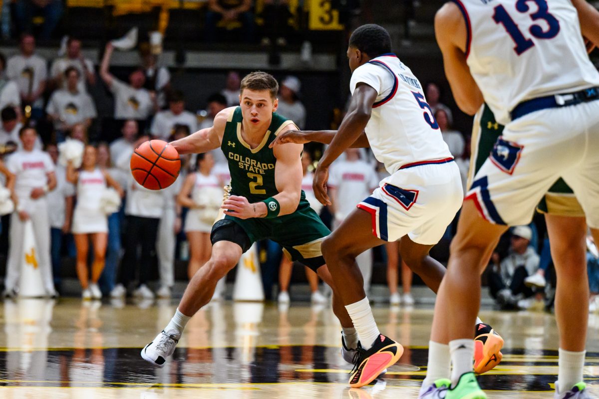 Colorado State University men's basketball guard Brandon Rechsteiner (2) looks for a teammate while avoiding University of Wyoming's defense during CSU's game against UW in UW's Arena-Auditorium Jan. 31.