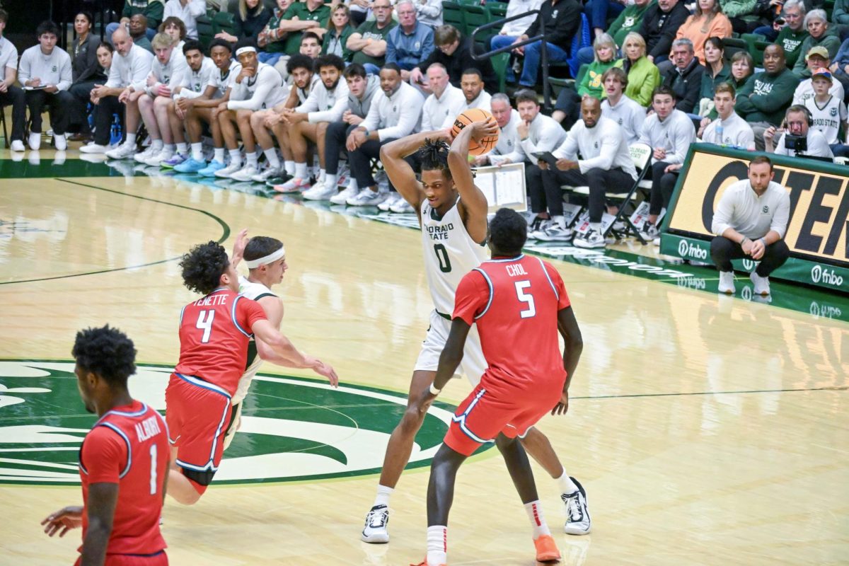 Carey Booth looks to find his best option in terms of passing the ball in Colorado State University's home game against the University of New Mexico Jan 6. CSU lost 80-70.
