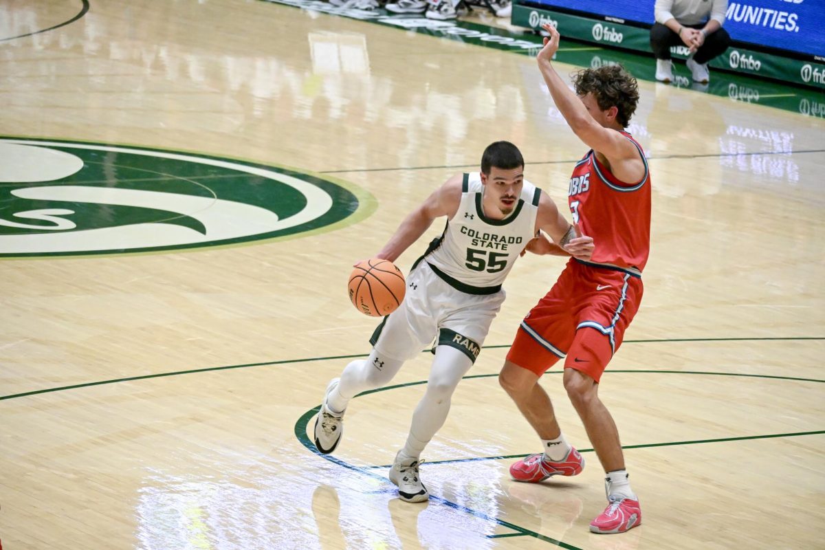 Jevin Muniz pushes past a New Mexico defender in Colorado State University's home game against the University of New Mexico Jan. 6. CSU lost 80-70.
