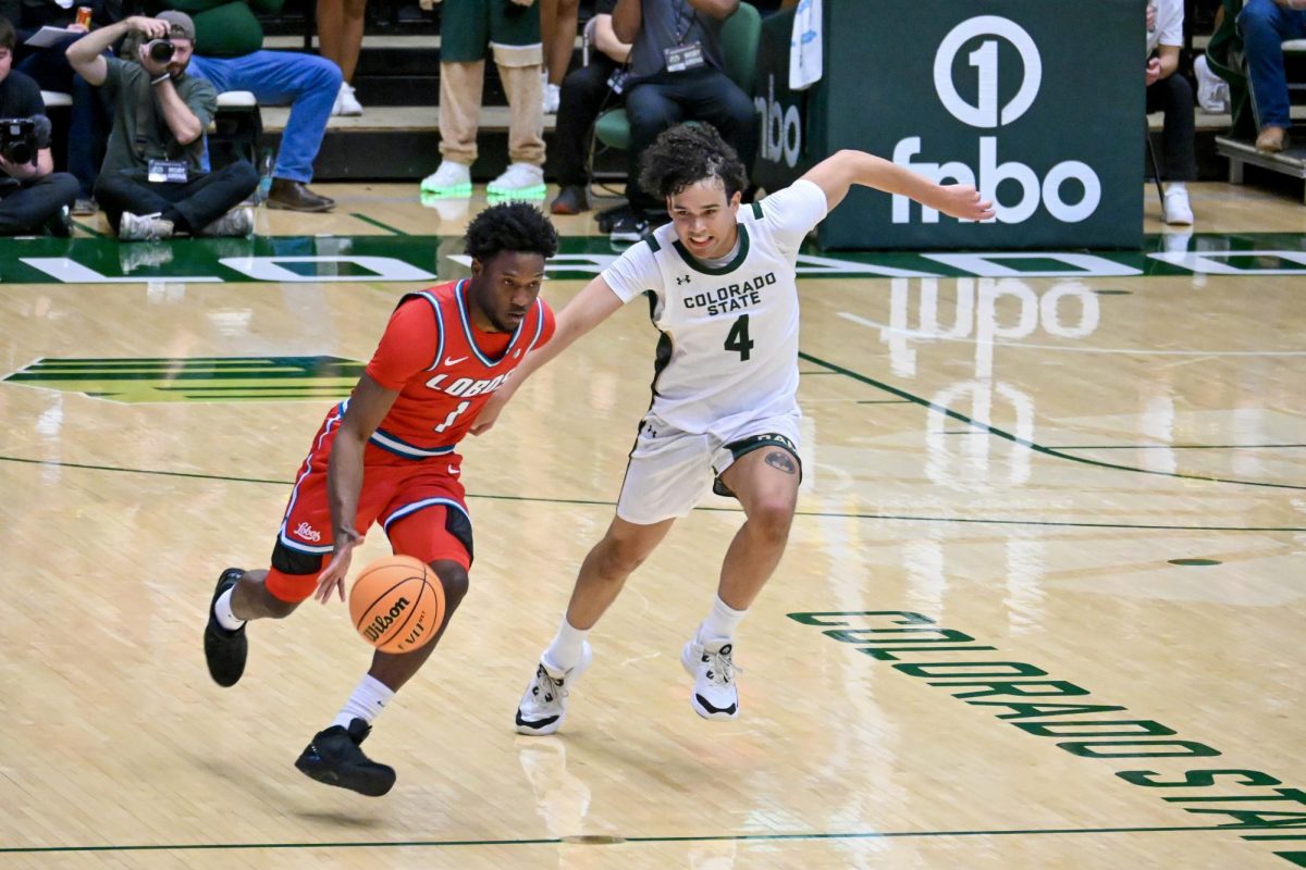Jase Butler rushes to defend the ball against a University of New Mexico player in Colorado State University's home game against the Lobos Jan. 6. CSU lost 80-70.